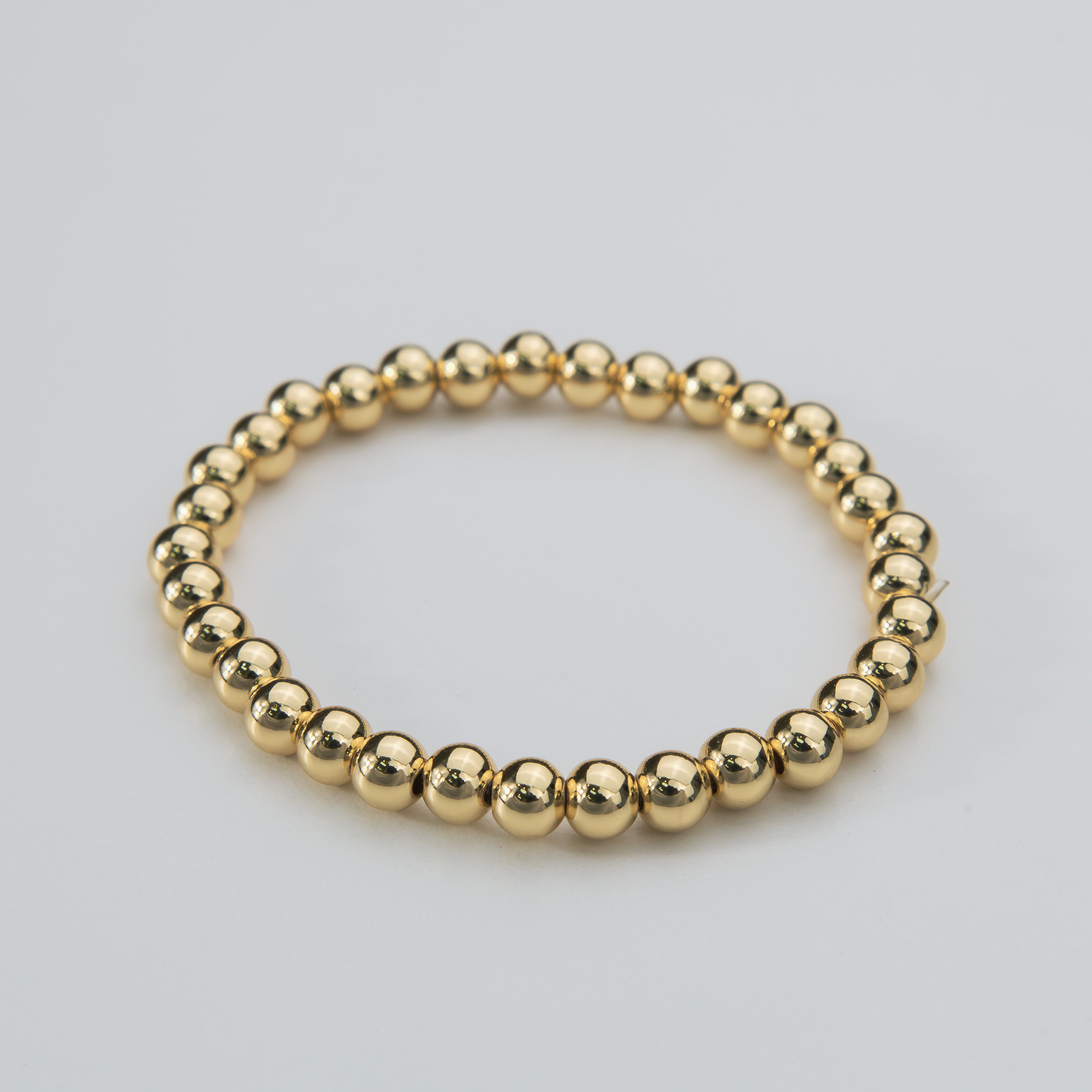 18675 Pulsera elástica Esfera Dorada de 6mm