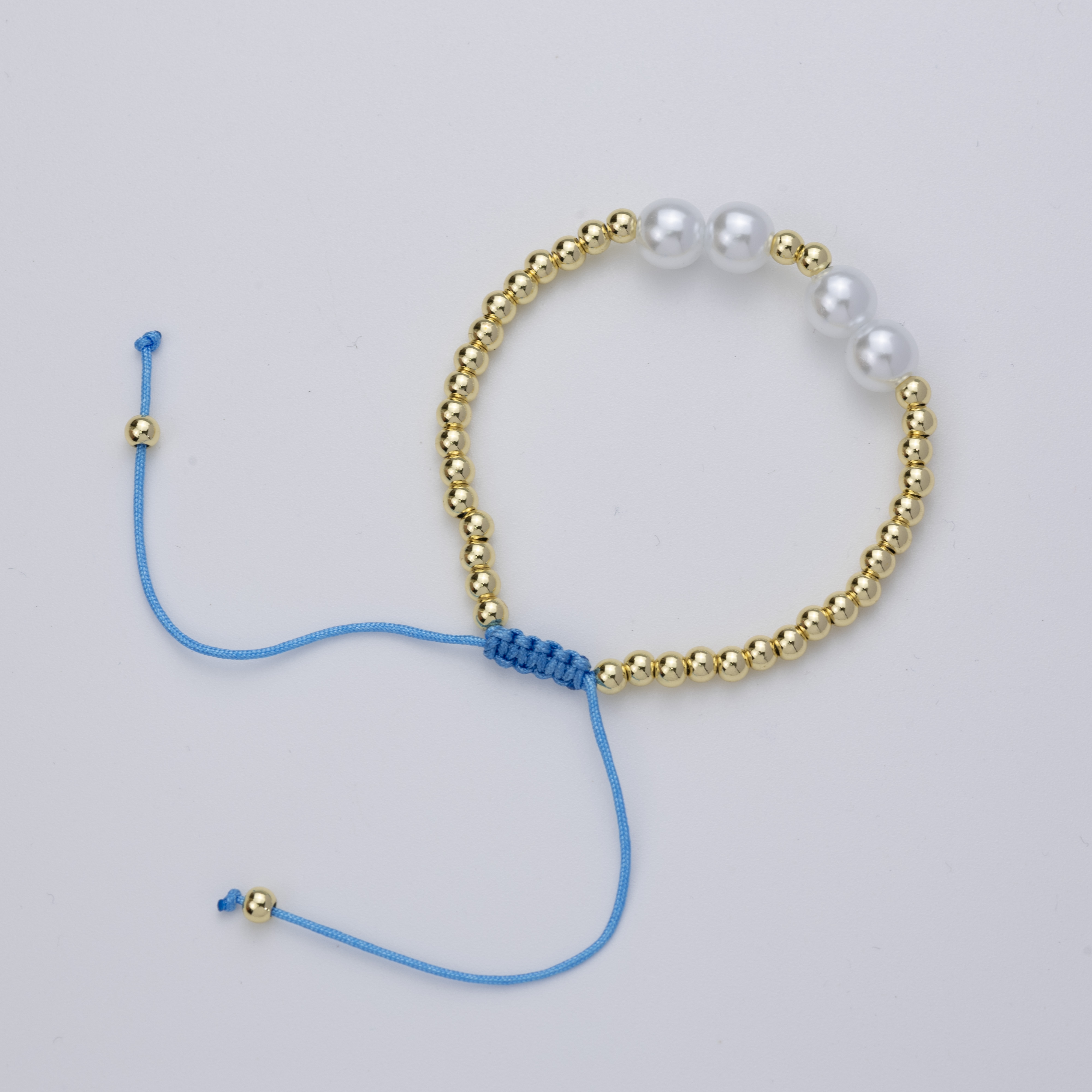 19489 Pulsera azul claro con perlas y cuentas doradas